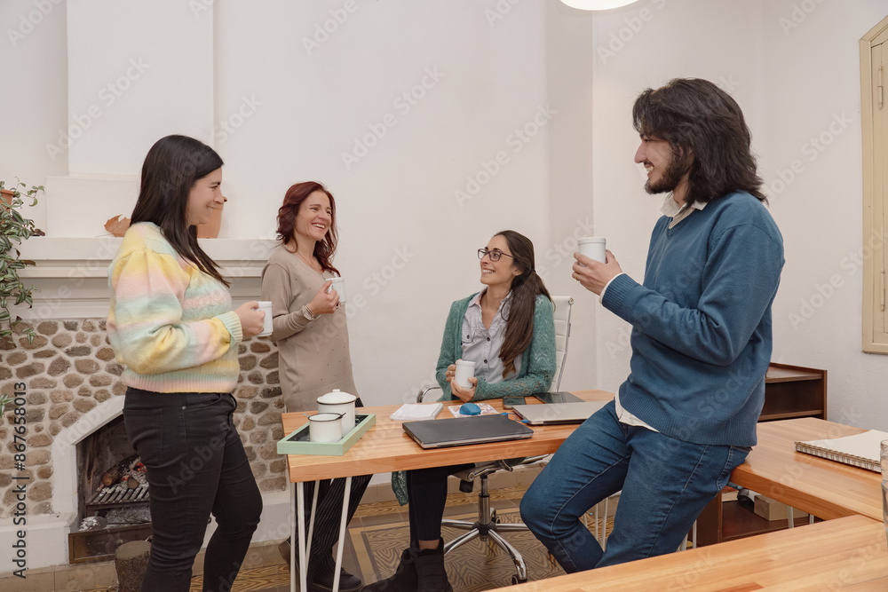Business team having a friendly coffee in the office. Business team having a friendly coffee in the office.