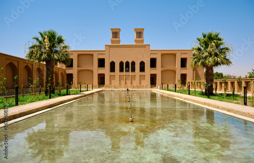 Adobe pavilion reflection over water pool and in Dowlatabad Garden photo