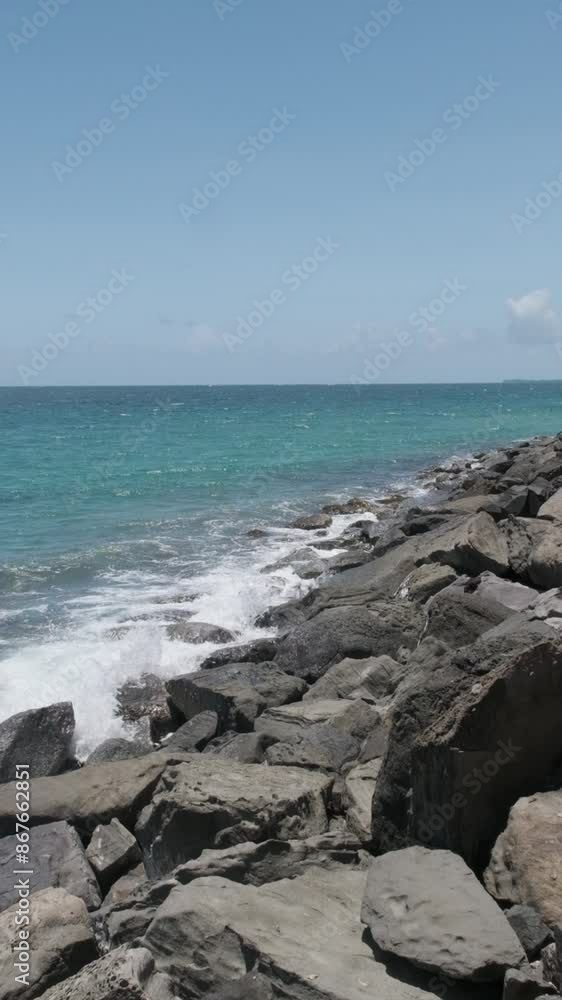 Vertical video, slow motion waves crashing against a rocky shore Vertical video, slow motion waves crashing against a rocky shore