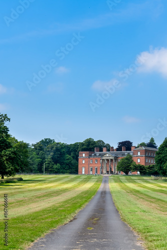 A view of the grounds of a Stately home in the UK, with a road in portrait orientation