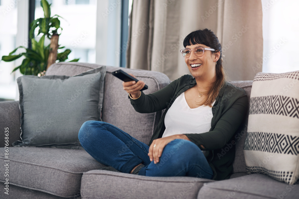 Woman, sofa and remote control for watching tv with smile for choice, comedy or subscription in home. Person, relax and happy on couch for streaming, movies or film with decision at house in Mexico Woman, sofa and remote control for watching tv with smile for choice, comedy or subscription in home. Person, relax and happy on couch for streaming, movies or film with decision at house in Mexico