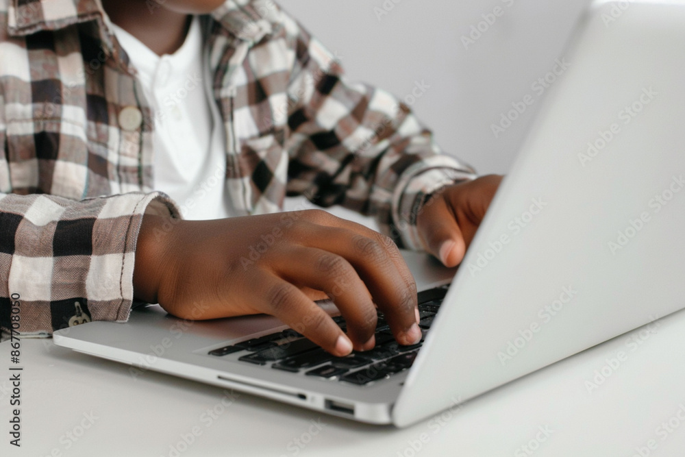 Naklejka premium African-American school teenage child kid hands using typing a laptop keyboard. Early exposure to technology digital learning development from childhood concept. Inafnt curiosity internet exploration
