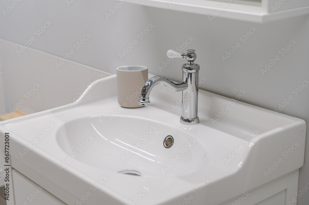 Fototapeta premium white sink and faucet in bright modern bathroom