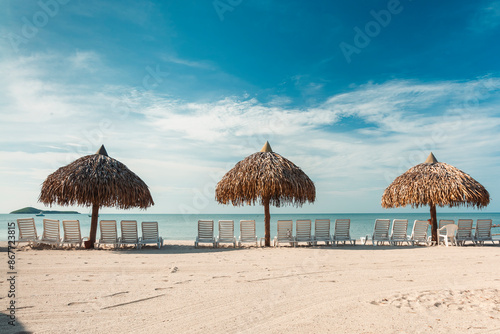 Portrait on the beach with blue sky and umbrellas with chairs to rest. Panama.  photo