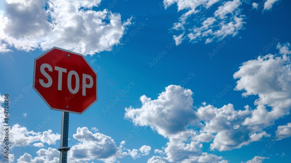 Stop sign under a blue sky with scattered clouds Stop sign under a blue sky with scattered clouds