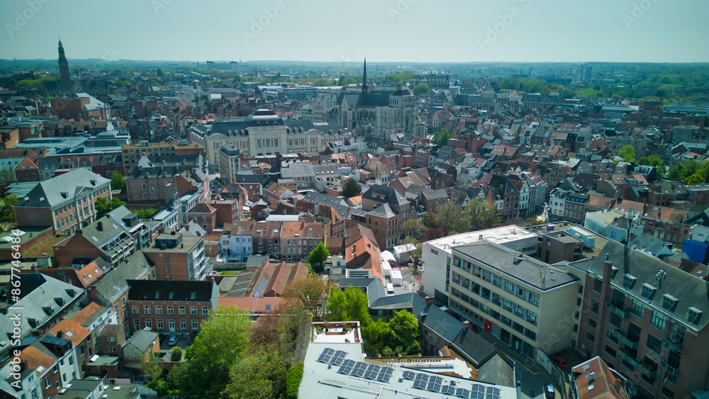 Fototapeta premium Enchanting aerial view of Bruges' historic old town captured by a drone at night! The illuminated medieval architecture, winding canals, and charming cobblestone streets create a magical and captivati