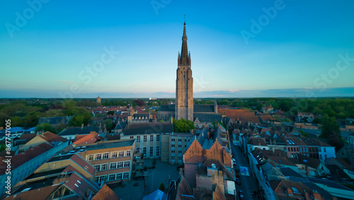 Enchanting aerial view of Bruges' historic old town captured by a drone at night! The illuminated medieval architecture, winding canals, and charming cobblestone streets create a magical and captivati photo