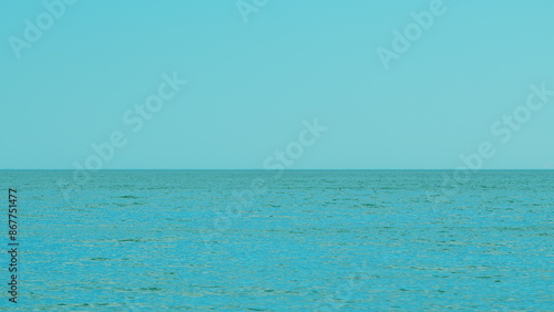 Calm Sea Horizon Background. Calm Blue Ocean Beach Water With Clear Blue Sky.