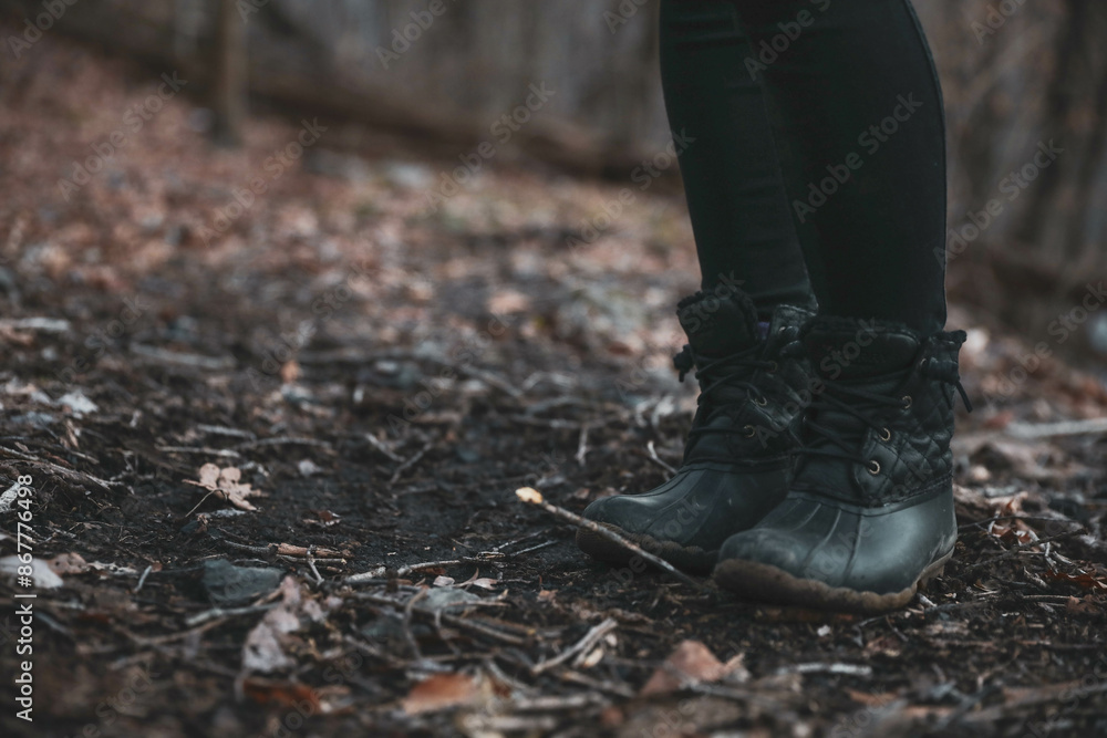 Close up of winter boots in the leaves, girl standing outside in the fall Close up of winter boots in the leaves, girl standing outside in the fall