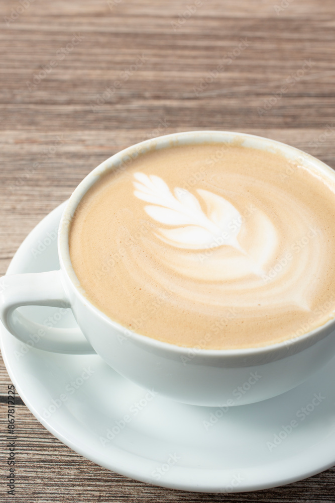 A view of a latte coffee drink, featuring latte art. A view of a latte coffee drink, featuring latte art.
