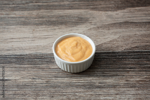 Фотография A view of a condiment cup of chipotle ranch.