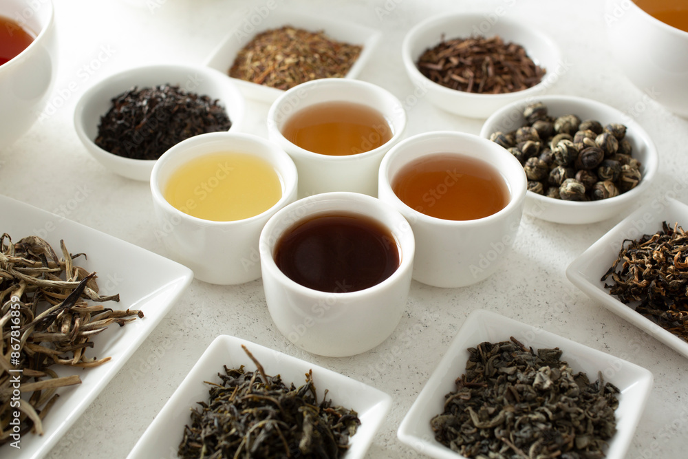 A view of assorted loose leaf tea and tea liquor. A view of assorted loose leaf tea and tea liquor.