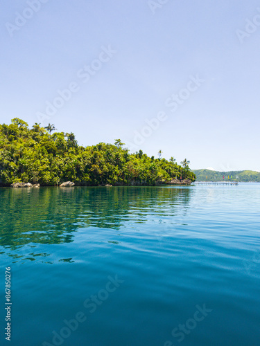 Tropical Island with green plants and blue sea. Surigao del Norte, Philippines. photo