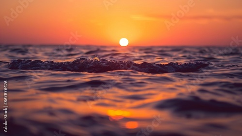 Beautiful sunset on the sea. Sea waves on the surface of the sea.