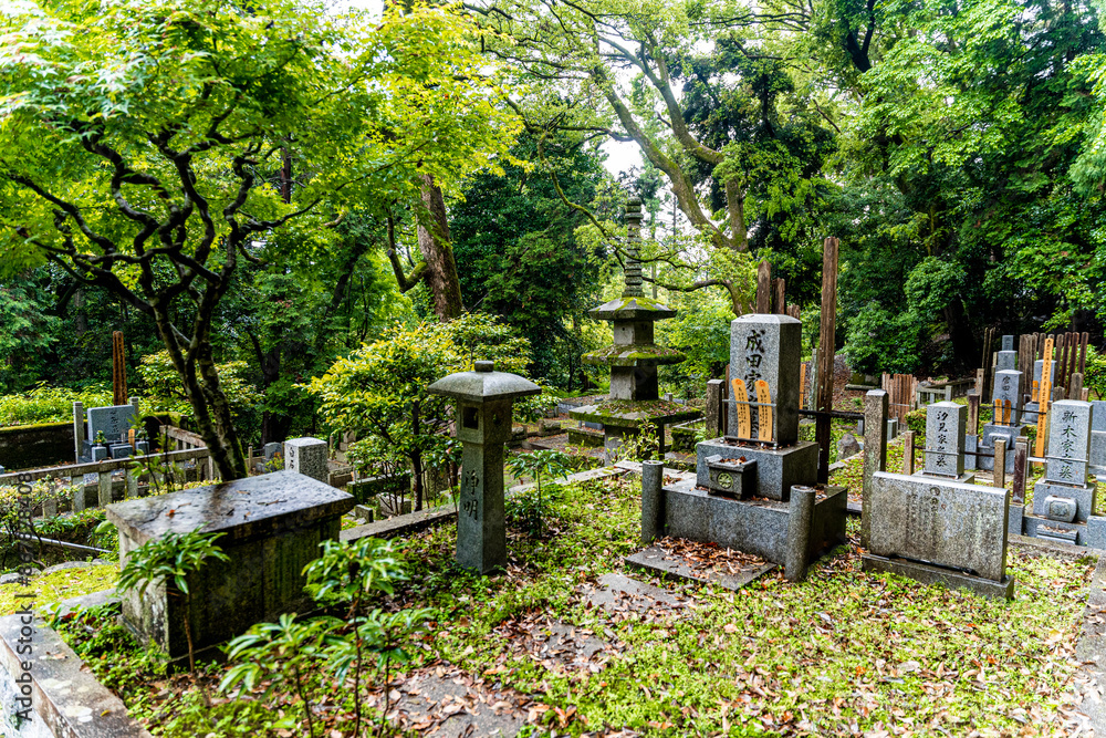 Graveyard with tombstones and a stone pagoda in the Honen-in Buddhist temple, near the Philosopher's path, Kyoto, Japan. Graveyard with tombstones and a stone pagoda in the Honen-in Buddhist temple, near the Philosopher's path, Kyoto, Japan.