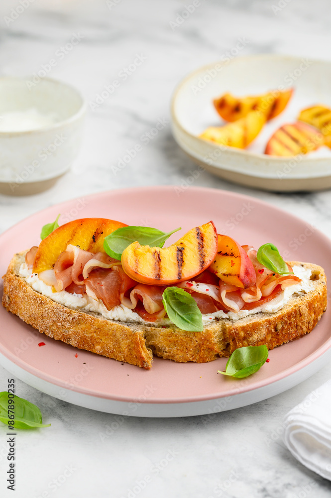 Sandwich with grilled peach, ham, cream cheese and basil. Delicious healthy snack. Selective focus Sandwich with grilled peach, ham, cream cheese and basil. Delicious healthy snack. Selective focus