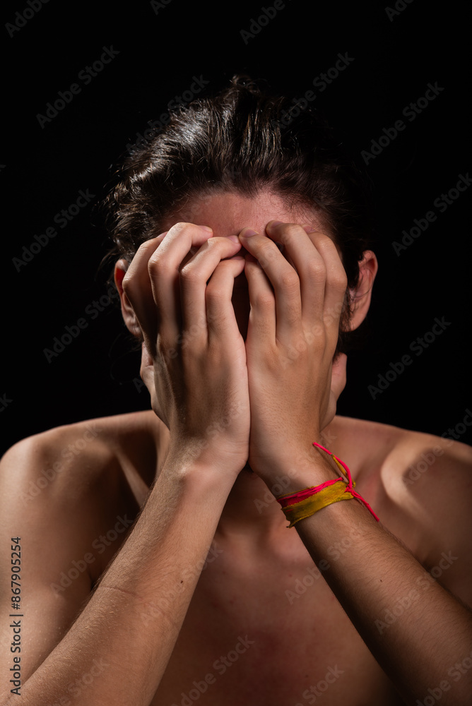 Young man, shirtless, scratching his face with both hands. Skin disease. Irritation, allergy. Young man, shirtless, scratching his face with both hands. Skin disease. Irritation, allergy.