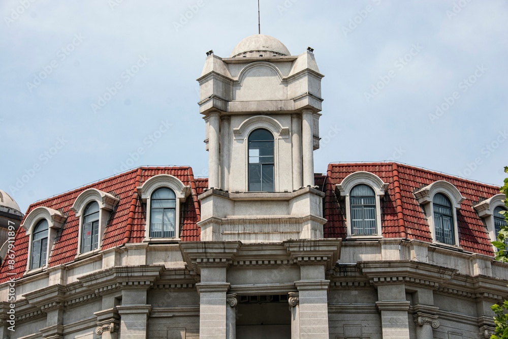 Obraz premium Historic European-style building with red-tiled roofs and ornate details in Wuhan, China