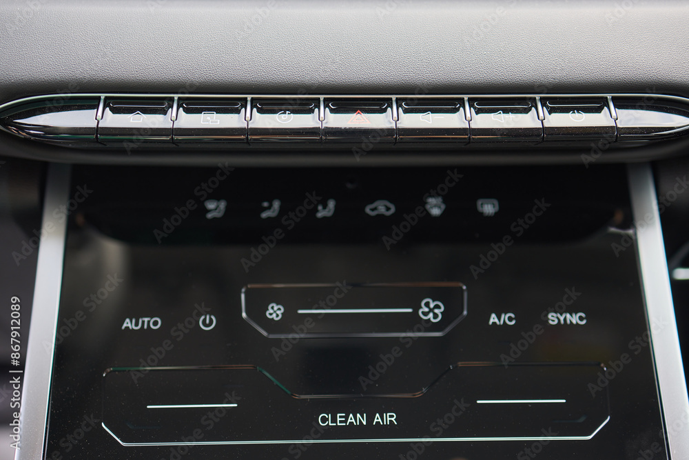 A detailed view of the advanced climate control system on a modern vehicles dashboard interior A detailed view of the advanced climate control system on a modern vehicles dashboard interior