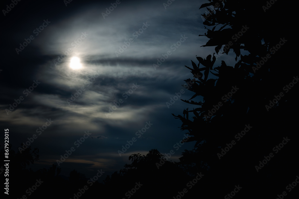 A dark sky with a moon and clouds A dark sky with a moon and clouds