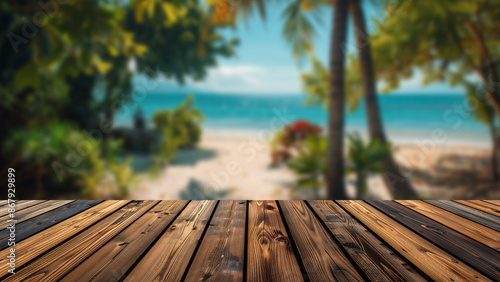 Empty wooden table in front of a blurred summer beach scene, featuring a tropical sand beach and palm trees, ideal for placing summer advertising products on the table. © Summit Art Creations