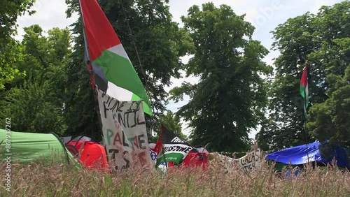 Students protesting peacefully for the Palestine-Israel conflict on the University of Bristol's campus. Flags and banners wave in the wind at the Palestine solidarity camp at Bristol University.