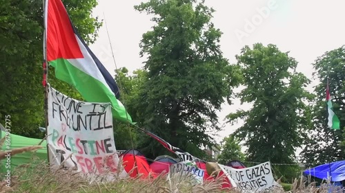 Students protesting peacefully for the Palestine-Israel conflict on the University of Bristol's campus. Flags and banners wave in the wind at the Palestine solidarity camp at Bristol University.