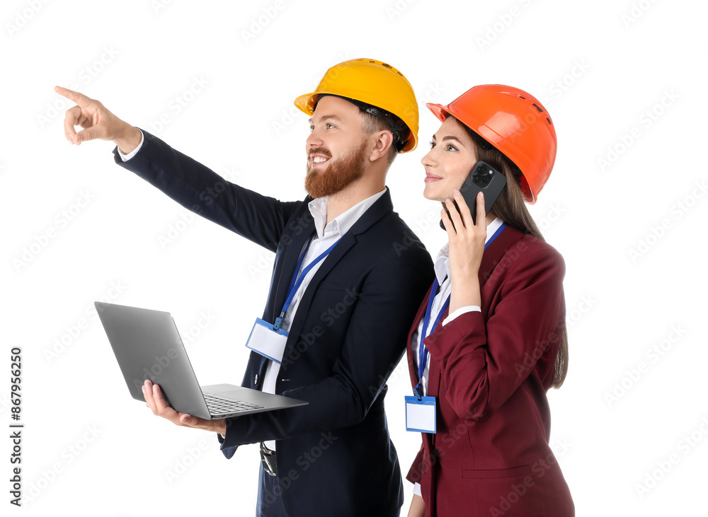 Engineer holding laptop while his colleague talking on smartphone against white background Engineer holding laptop while his colleague talking on smartphone against white background