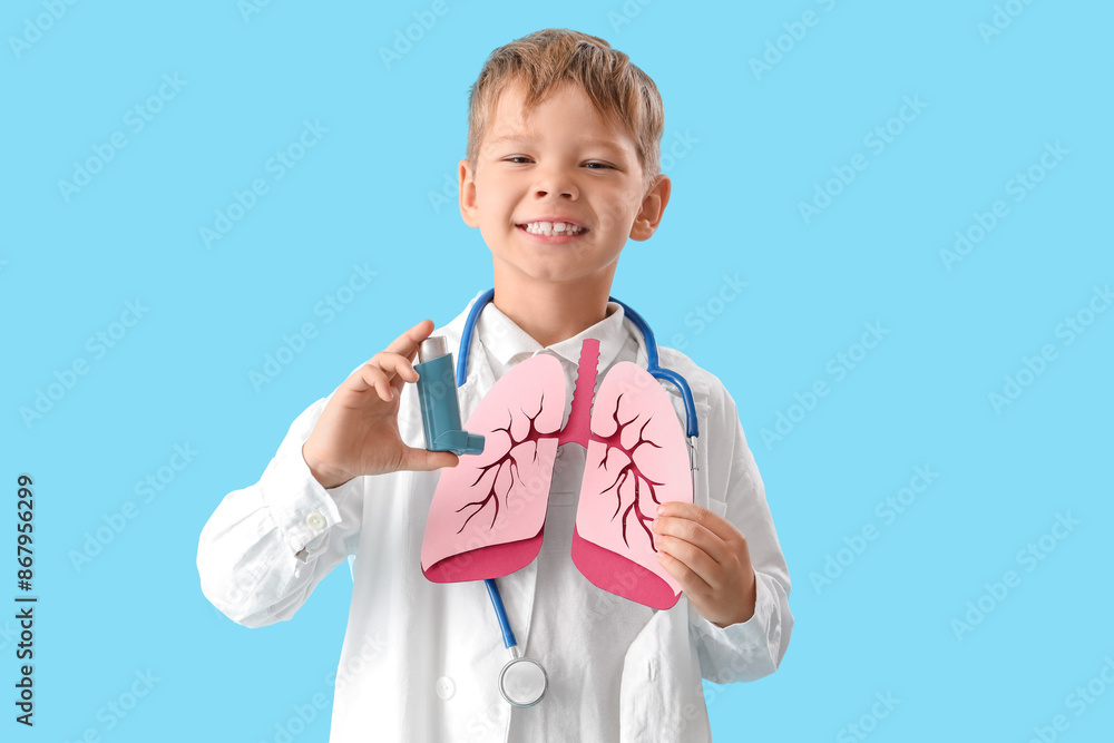 Little doctor with paper lungs and inhaler on blue background Little doctor with paper lungs and inhaler on blue background