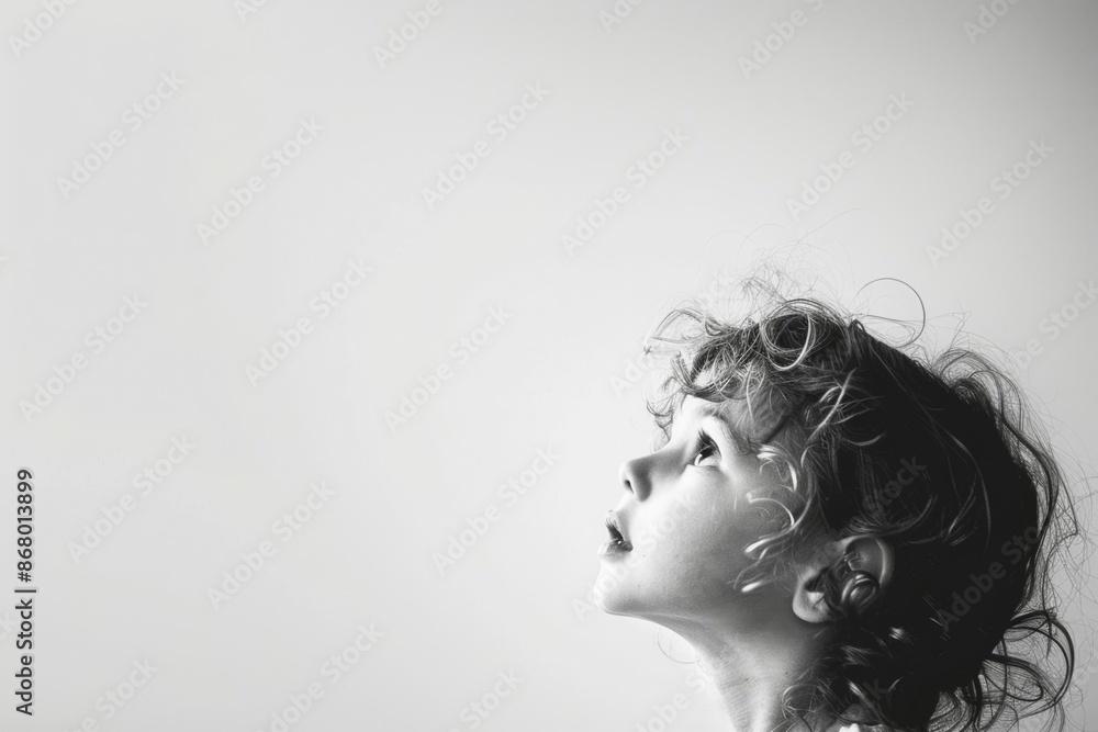 Fototapeta premium Child Looking Upwards in Black and White Profile Shot