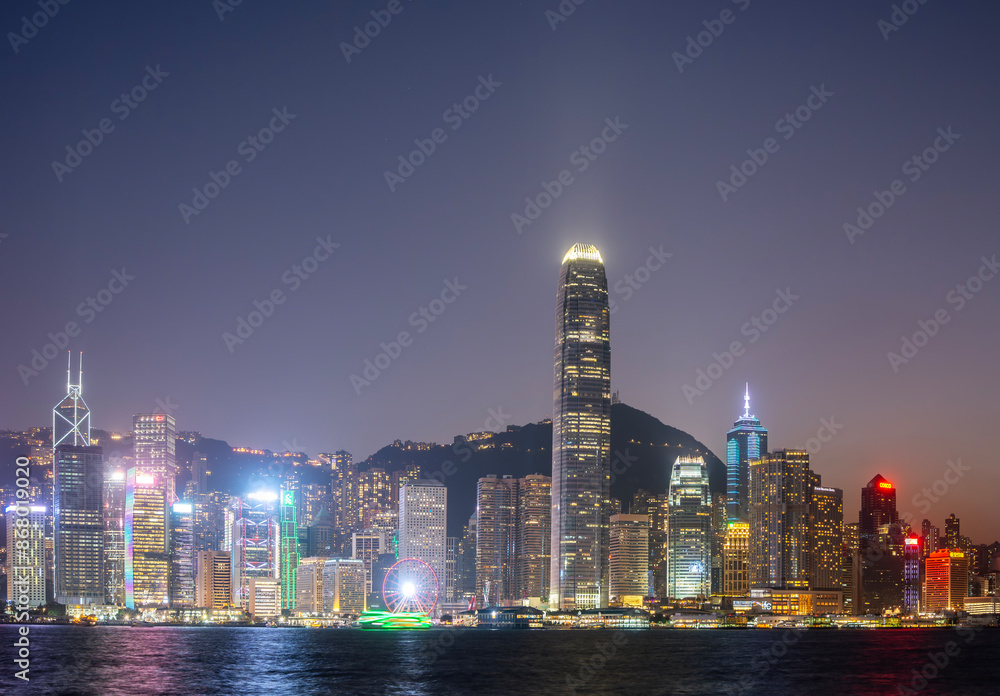 Fototapeta premium Hong Kong downtown skyline across Victoria harbor at night, Hong Kong, China.