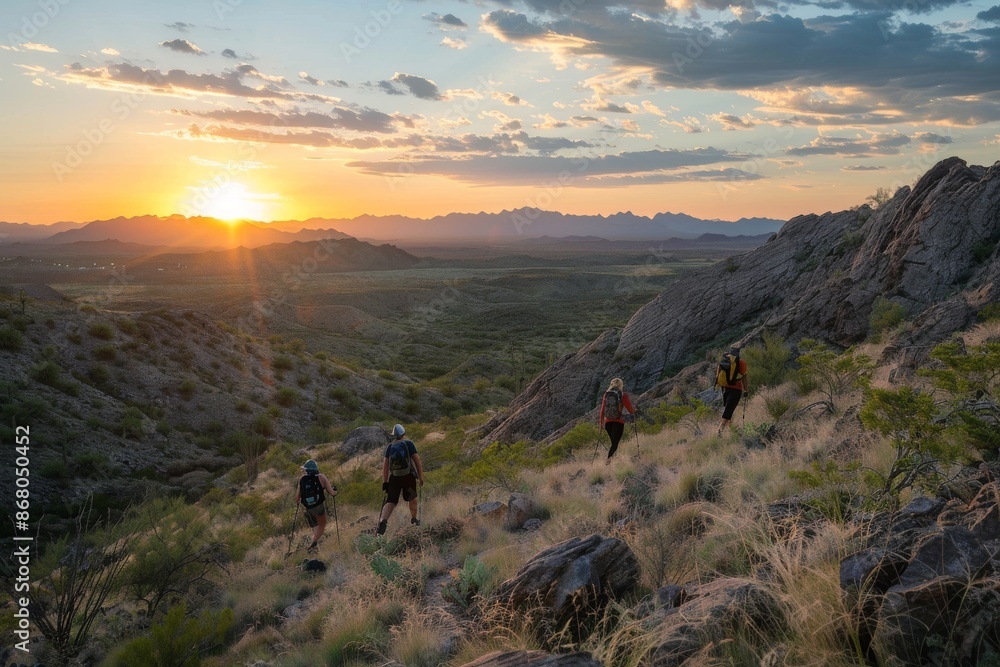 Obraz premium Hikers Silhouette at Sunset on a Mountain Trail