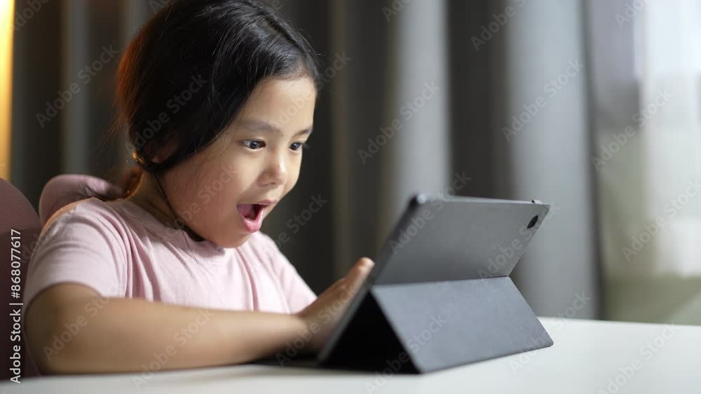 asian child playing game on tablet or kid girl computer learning to wow excited and fun study online or people enjoy learn from home school by video call studying to touch screen technology education asian child playing game on tablet or kid girl computer learning to wow excited and fun study online or people enjoy learn from home school by video call studying to touch screen technology education