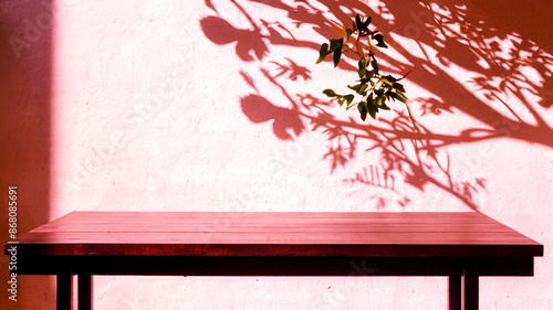 Empty wood table top on beige wall texture with tree leaves shadow background

