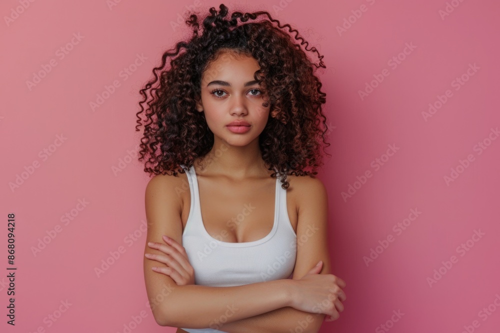 Confident businesswoman with curly hair on pink background. Confident businesswoman with curly hair on pink background.
