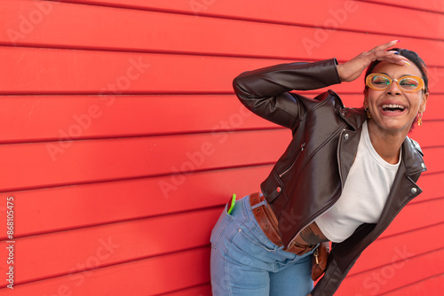 afro american latin young woman or girl on red background looking