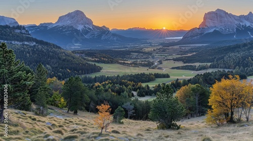 Fototapeta Naklejka Na Ścianę i Meble -  A beautiful mountain landscape with a sun setting in the background