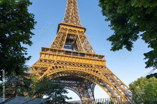 Base structure of Eiffel tower in Paris, France. Early golden morning light photo