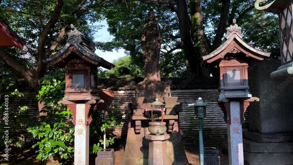 Japanese shrine with traditional lanterns and lush green trees on a sunny day Japanese shrine with traditional lanterns and lush green trees on a sunny day