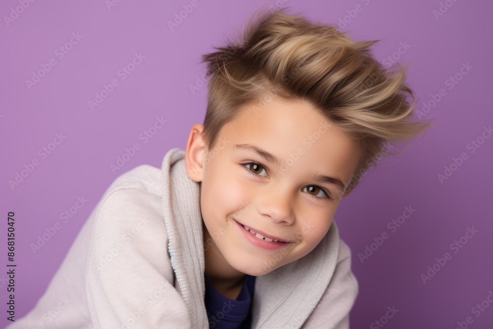 Portrait of a cute smiling little boy in a white sweatshirt on a purple background Portrait of a cute smiling little boy in a white sweatshirt on a purple background