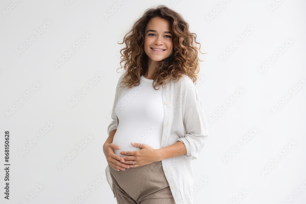 Portrait of happy pregnant woman smiling and touching her belly over white background Portrait of happy pregnant woman smiling and touching her belly over white background