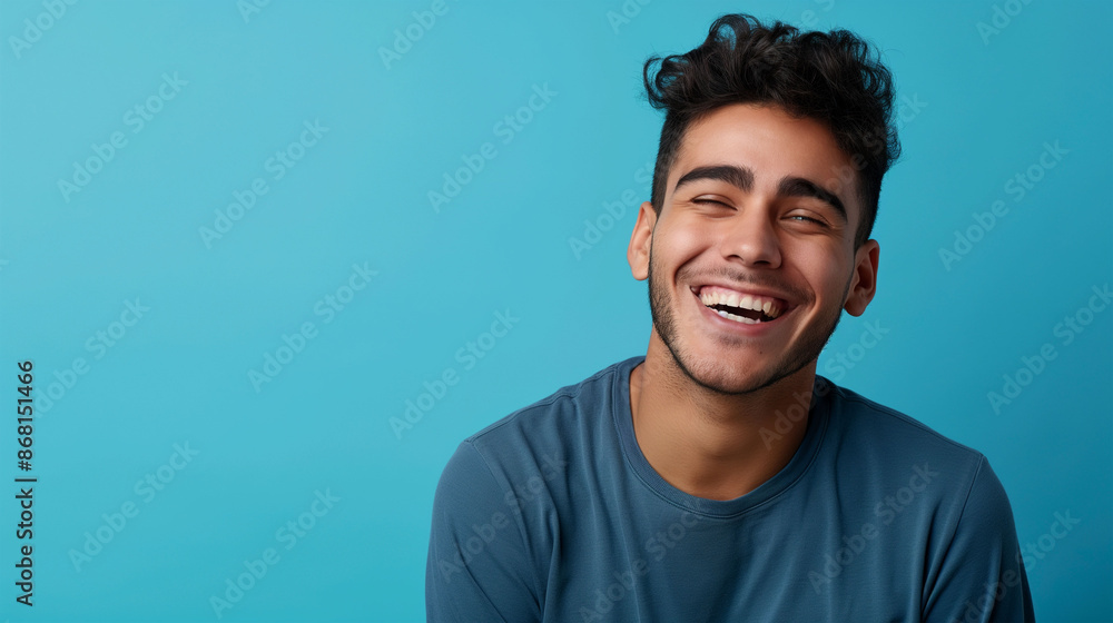 Happy joyful smiling young indian man looking aside up thinking of new good opportunities, dreaming, feeling inspired and proud standing isolated on blue background. Portrait Happy joyful smiling young indian man looking aside up thinking of new good opportunities, dreaming, feeling inspired and proud standing isolated on blue background. Portrait