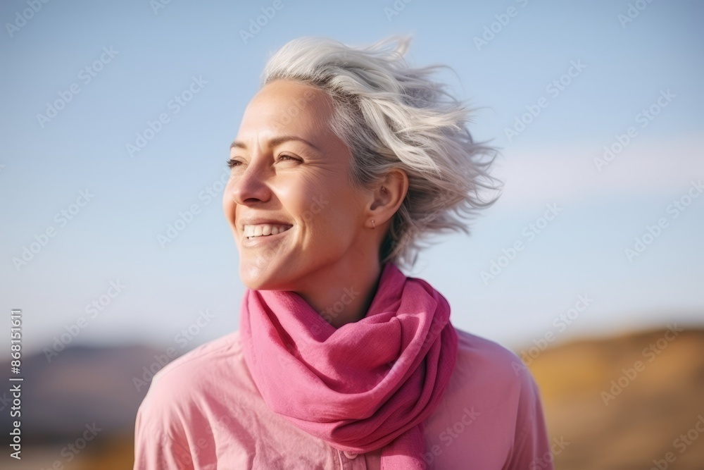 Portrait of a happy senior woman with wind blowing her hair outdoors Portrait of a happy senior woman with wind blowing her hair outdoors