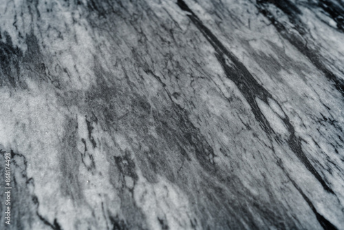 Gray marble texture with natural white veining patterns. Smooth, polished stone surface for countertops
