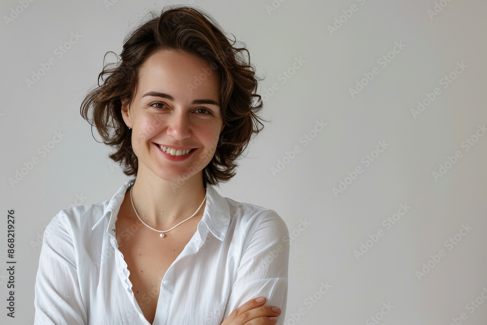 Smiling young professional business woman wearing business smart casual clothes posing isolated on white wall background with copy space Smiling young professional business woman wearing business smart casual clothes posing isolated on white wall background with copy space