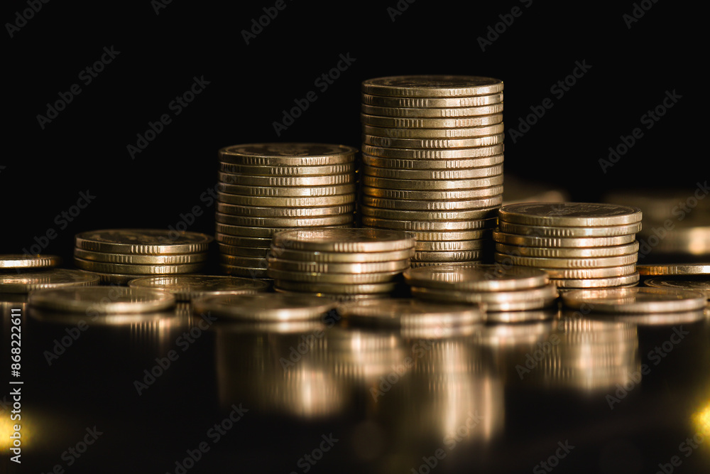 Golden money coin stack on black background. Symbolizing wealth, success, and financial growth in banking and business. Financial background concept. Golden money coin stack on black background. Symbolizing wealth, success, and financial growth in banking and business. Financial background concept.