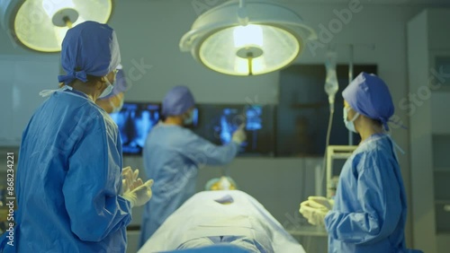 Doctor explain to his team about the process to treat patient in operation room of hospital.