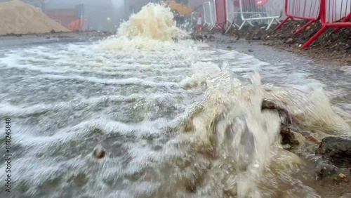 Water Main Break Floods Street in Urban Construction Zone