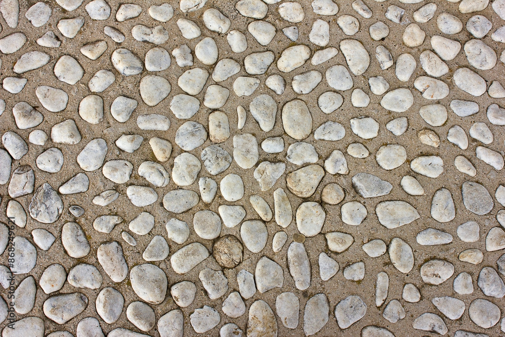 Abstract background cement surface with small stones and gravel close-up Abstract background cement surface with small stones and gravel close-up