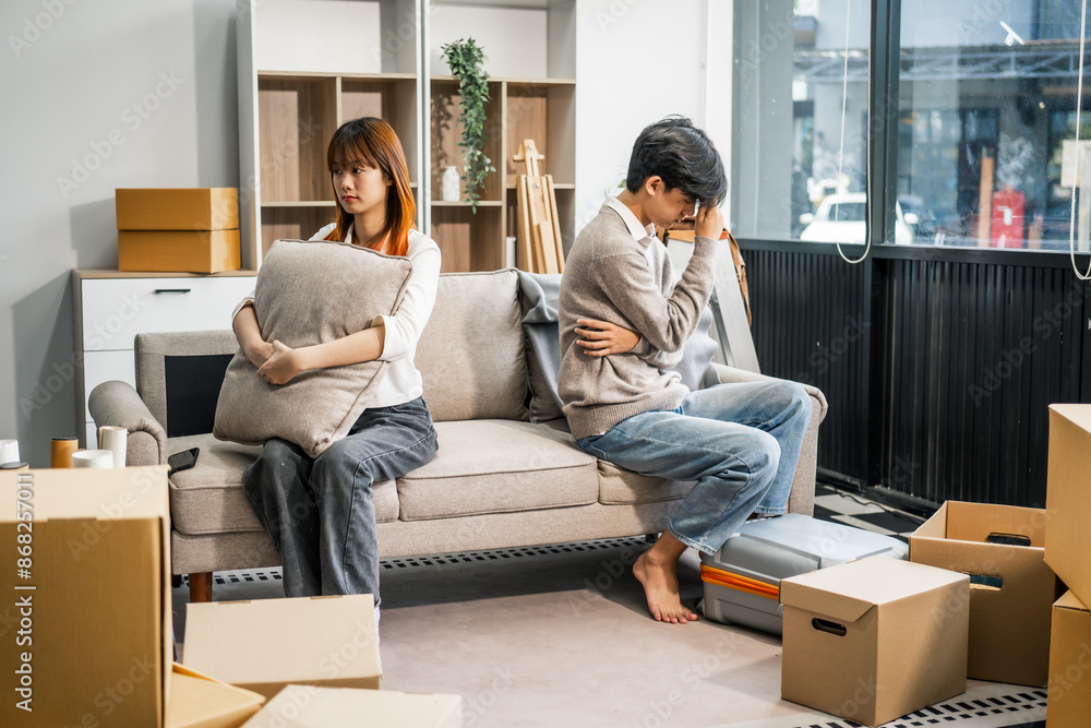 A man and a woman sit on a sofa, visibly upset and arguing, reflecting marital conflict and relationship stress at home. Their discussion shows signs of disagreement and emotional strain. A man and a woman sit on a sofa, visibly upset and arguing, reflecting marital conflict and relationship stress at home. Their discussion shows signs of disagreement and emotional strain.